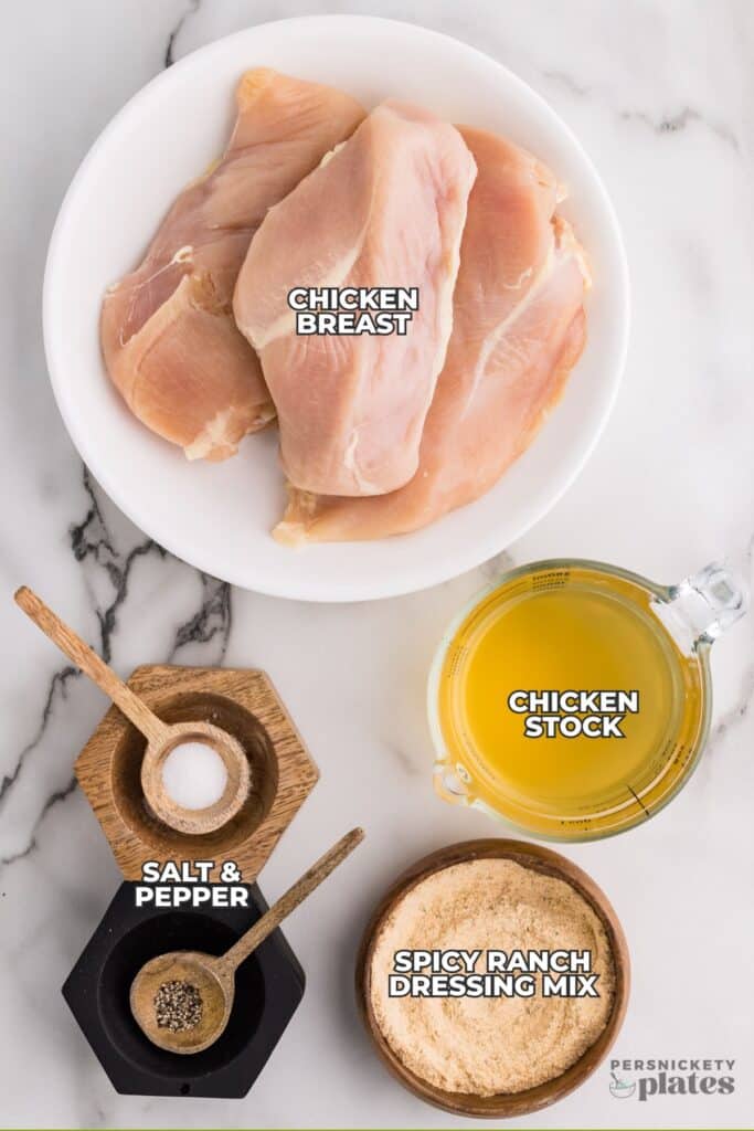 Ingredients for spicy ranch chicken labeled on a marble surface.