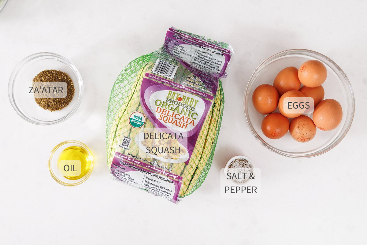 Labeled ingredients for delicata squash egg cups on a white counter.