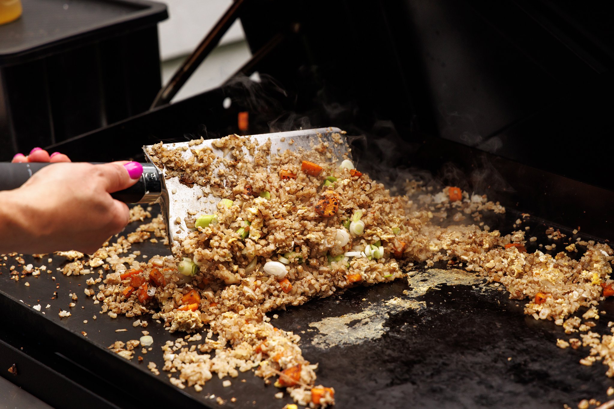 Tossing together shrimp fried cauliflower rice.