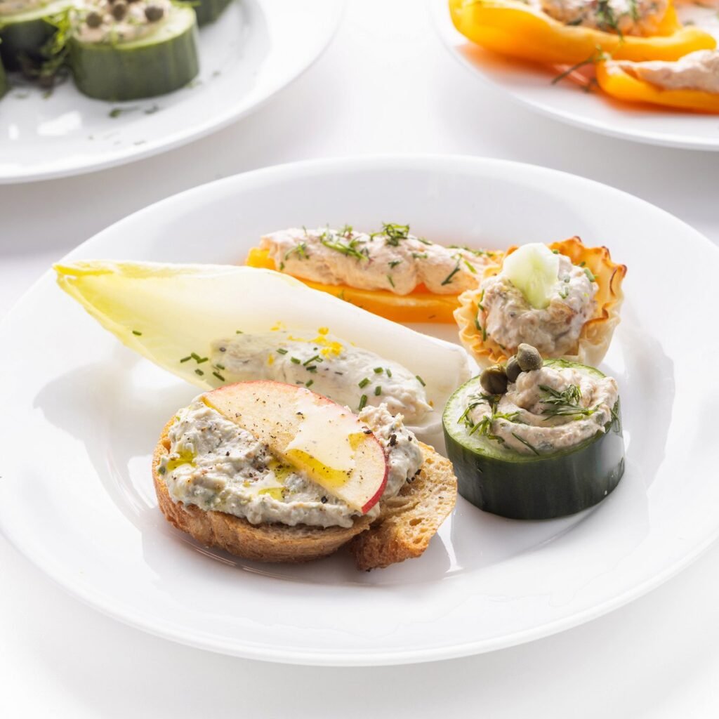 White plate with 5 no-cook holiday appetizers with smoked fish dip on it.