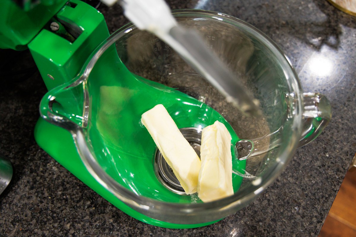 Two sticks of butter in the bowl of a stand mixer.