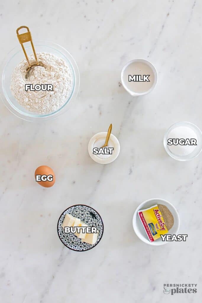 baking ingredients laid out on a marble countertop.
